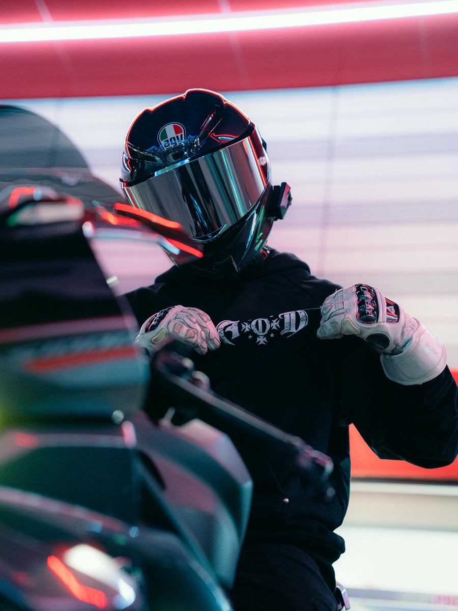 Helmeted rider wearing Adapt or Die